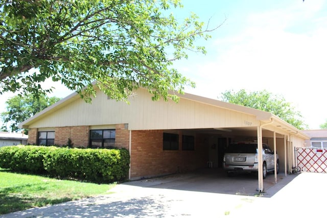 view of side of home with a carport