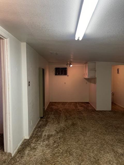 1807 W 9th St, Fort Stockton, TX 79735 - basement with a textured ceiling, carpet floors, and an AC wall unit