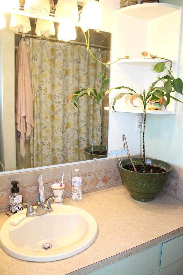 bathroom featuring vanity and backsplash