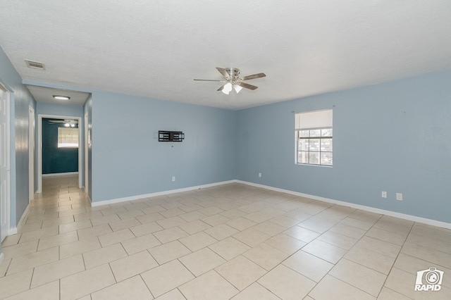 111 W Pine Ave, Midland, TX 79705 - empty room with a ceiling fan, light tile patterned flooring, and a textured ceiling