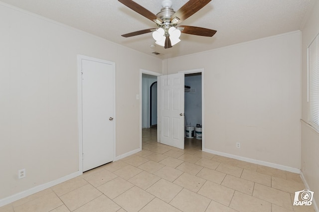 111 W Pine Ave, Midland, TX 79705 - spare room with ceiling fan, ornamental molding, light tile patterned flooring, and a textured ceiling
