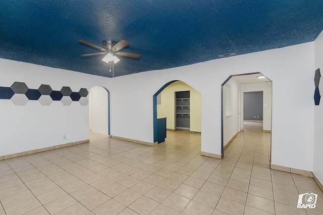 111 W Pine Ave, Midland, TX 79705 - spare room featuring ceiling fan, light tile patterned flooring, and arched walkways