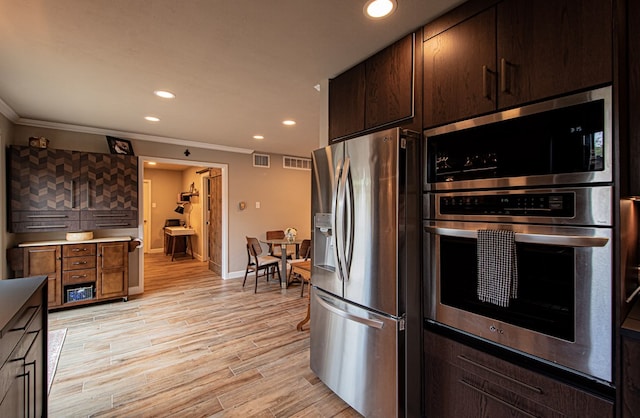 kitchen with dark brown cabinets, crown molding, stainless steel appliances, and light hardwood / wood-style flooring