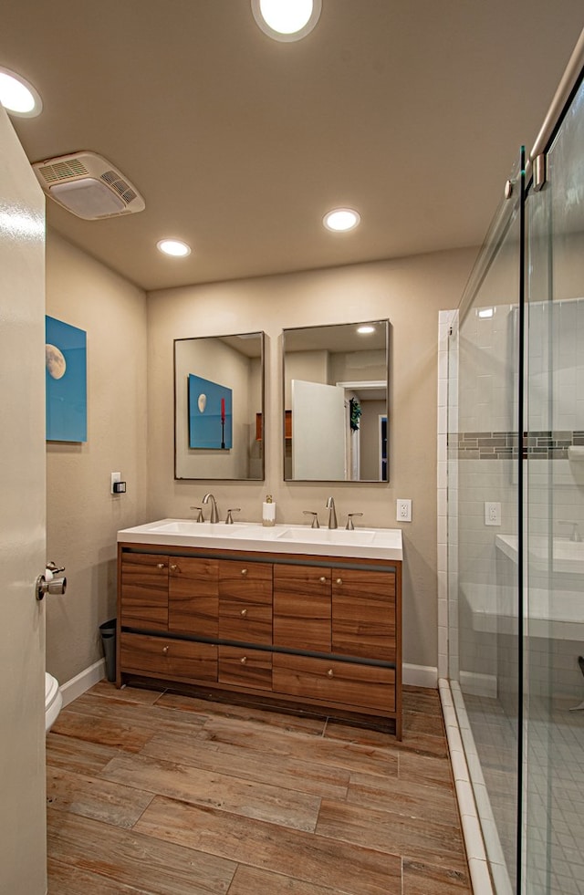 bathroom with vanity, toilet, and walk in shower