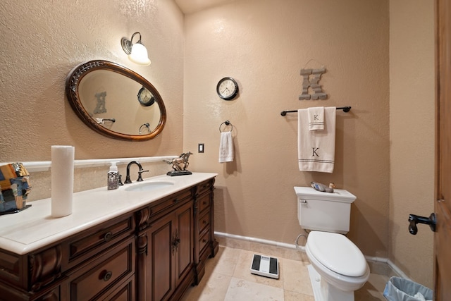 bathroom featuring tile patterned flooring, vanity, and toilet