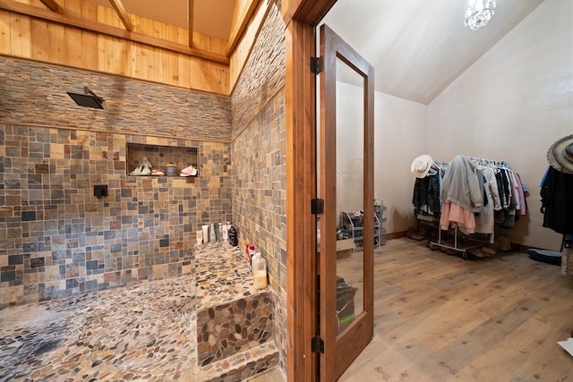 bathroom featuring lofted ceiling and wood-type flooring