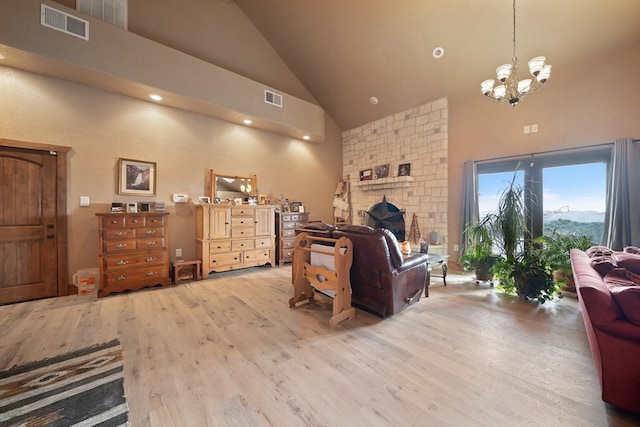 living room featuring a chandelier, hardwood / wood-style flooring, and high vaulted ceiling