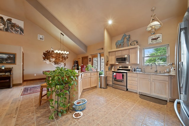 kitchen featuring pendant lighting, light brown cabinets, sink, appliances with stainless steel finishes, and light hardwood / wood-style floors