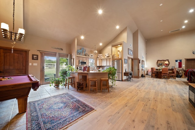 game room with light hardwood / wood-style flooring, high vaulted ceiling, and pool table