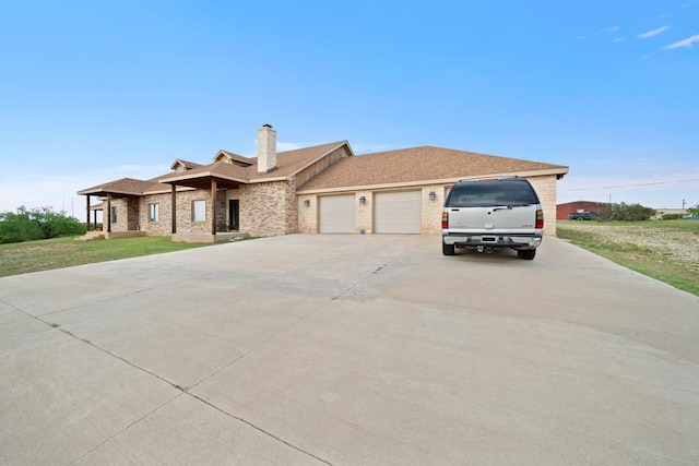 view of front of house featuring a garage and a front lawn