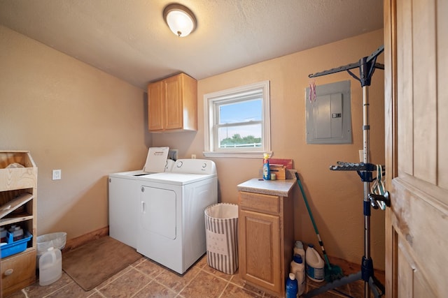 washroom featuring washer and clothes dryer, cabinets, and electric panel