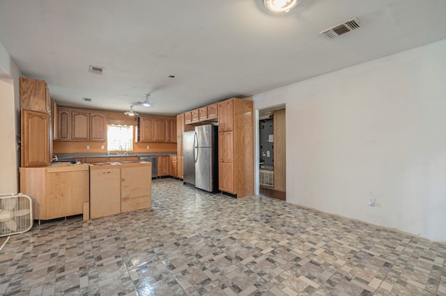 kitchen featuring kitchen peninsula, sink, and stainless steel appliances