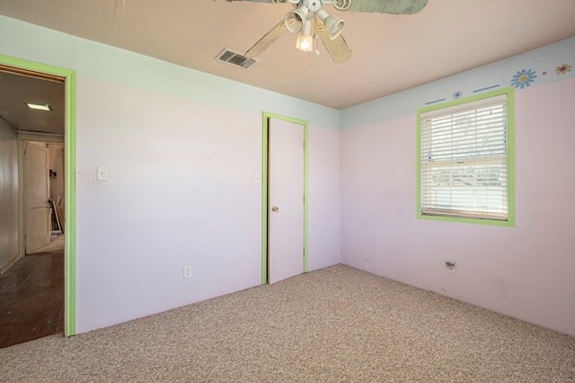 unfurnished bedroom featuring ceiling fan, a closet, and carpet