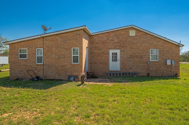 back of property featuring a yard