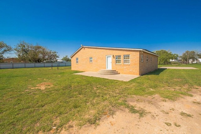 back of property with a lawn, a patio, and central AC unit