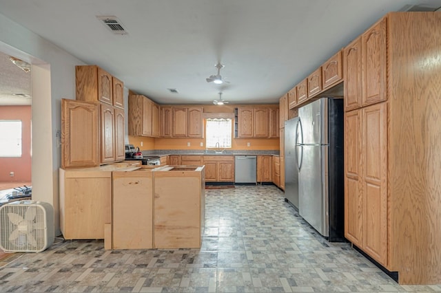 kitchen featuring stainless steel appliances, a wealth of natural light, and sink