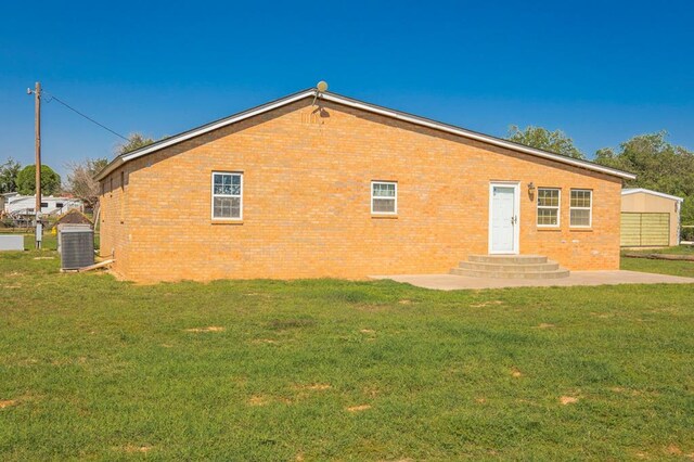 rear view of property with a patio area and a yard