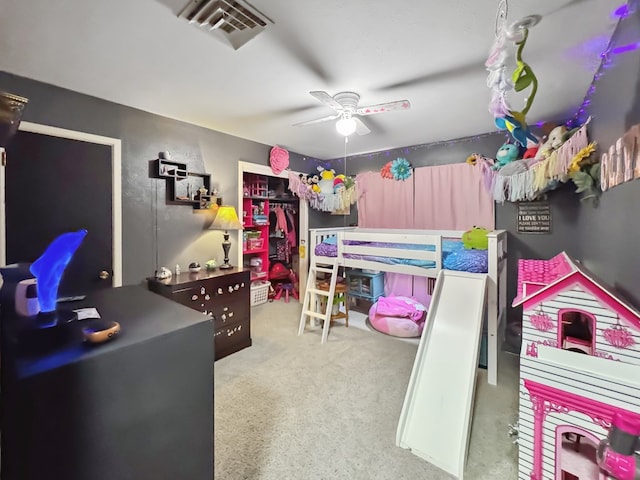 carpeted bedroom featuring visible vents and a ceiling fan