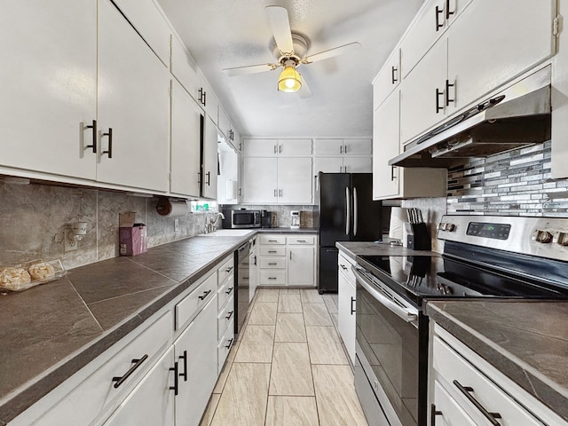 kitchen with under cabinet range hood, stainless steel appliances, a ceiling fan, white cabinets, and tasteful backsplash