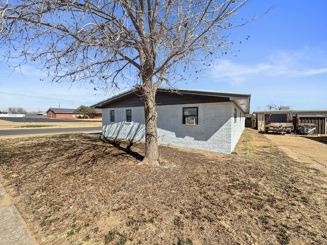 view of property exterior with brick siding