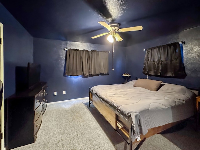 bedroom featuring carpet floors, a ceiling fan, and baseboards