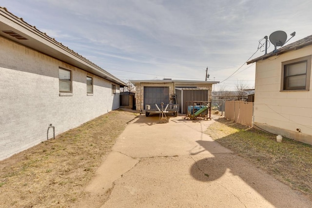 view of yard with fence and an outdoor structure