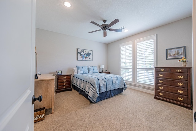 bedroom with light colored carpet, ceiling fan, recessed lighting, and a textured ceiling