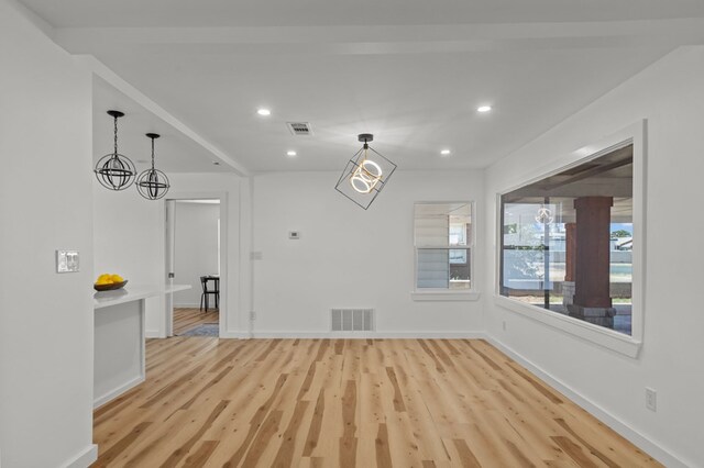 interior space featuring a notable chandelier and light wood-type flooring