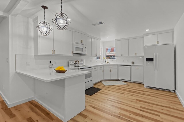 kitchen with light hardwood / wood-style flooring, white cabinets, and white appliances