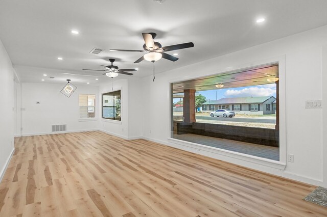 unfurnished living room featuring light hardwood / wood-style flooring and ceiling fan