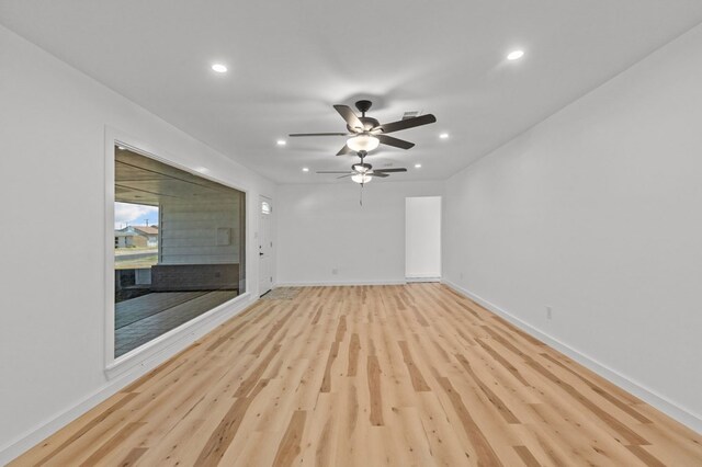 empty room featuring ceiling fan and light hardwood / wood-style flooring