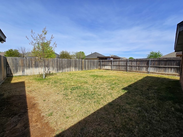 view of yard with a fenced backyard