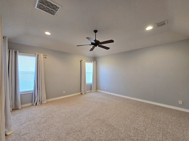 unfurnished room with visible vents, baseboards, and light carpet