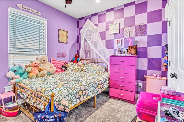 bedroom featuring ceiling fan and carpet