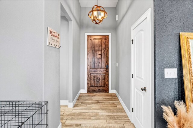 entryway featuring a chandelier and light wood-type flooring