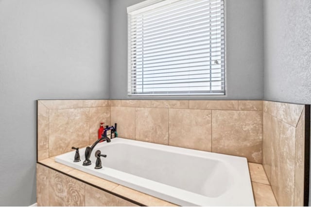 bathroom with tiled bath