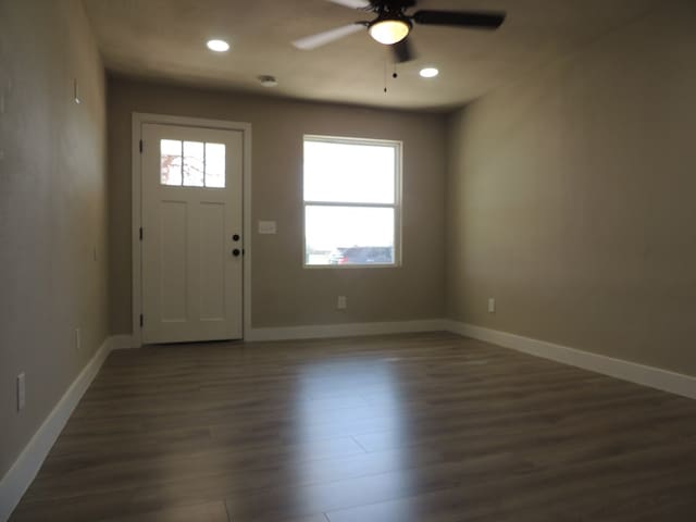 entryway with dark hardwood / wood-style floors and ceiling fan