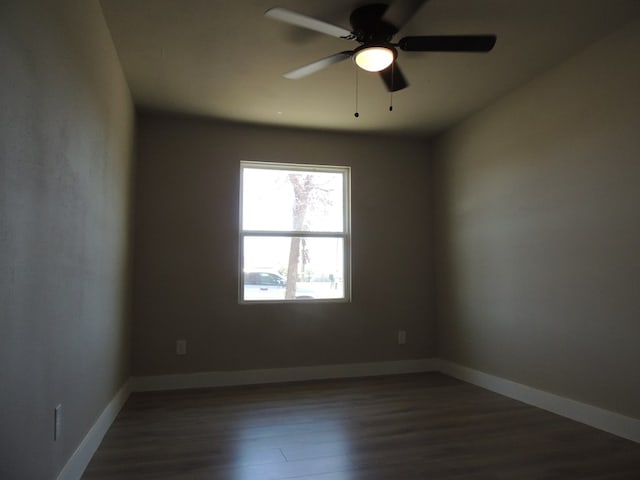 spare room featuring ceiling fan and dark hardwood / wood-style floors