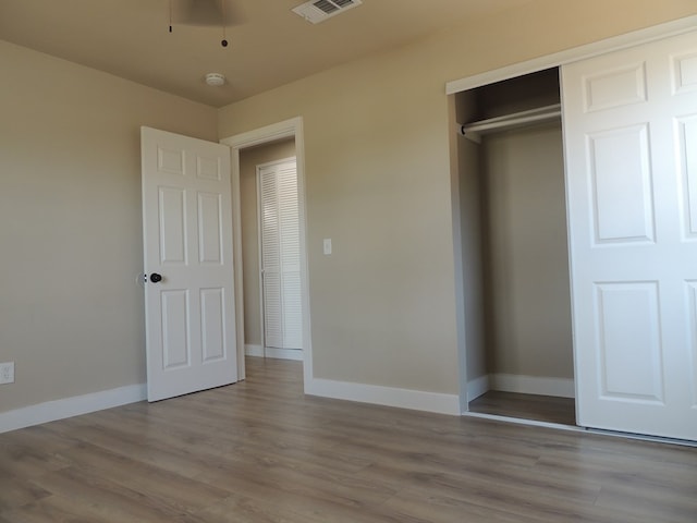 unfurnished bedroom with a closet and light hardwood / wood-style flooring