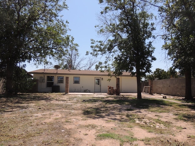 back of house featuring cooling unit