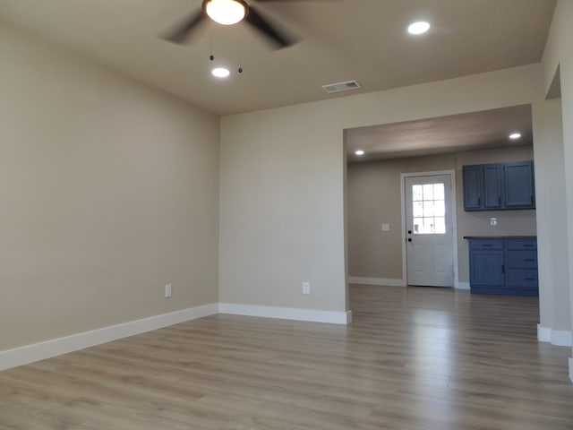 unfurnished living room featuring ceiling fan and light hardwood / wood-style flooring