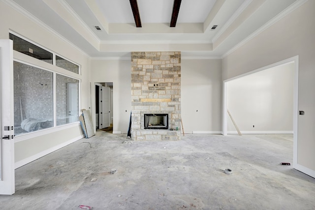 unfurnished living room with a high ceiling, beam ceiling, and a stone fireplace