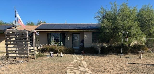 view of front facade with solar panels