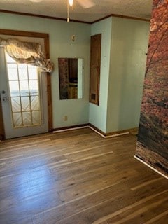 empty room with hardwood / wood-style floors, ceiling fan, and ornamental molding