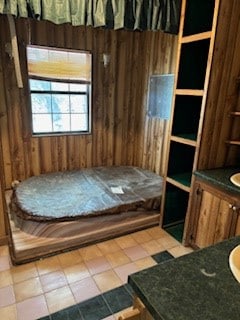 tiled bedroom with wood walls