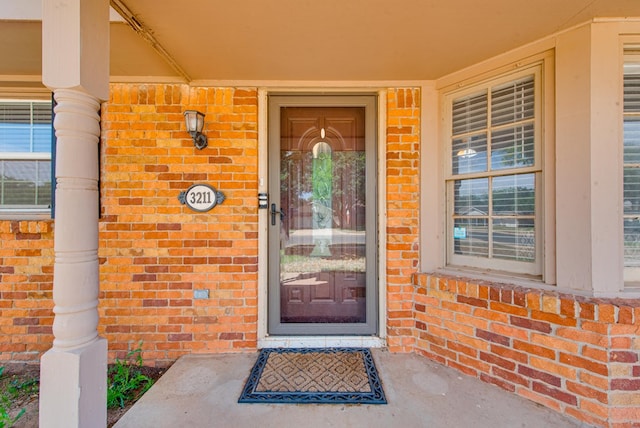 3211 W Shandon Ave, Midland, TX 79705 - doorway to property featuring brick siding and covered porch