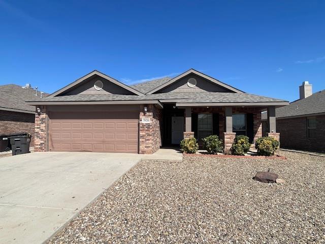 single story home with a garage, concrete driveway, and brick siding