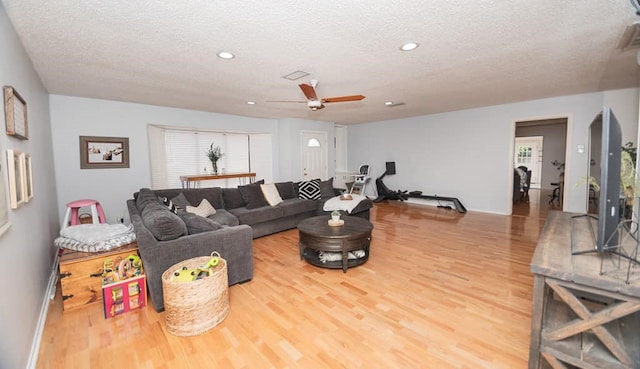 2718 Central Ave, Big Spring, TX 79720 - living area with a textured ceiling, a ceiling fan, wood finished floors, recessed lighting, and healthy amount of natural light