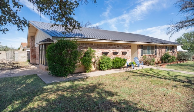 2718 Central Ave, Big Spring, TX 79720 - view of front facade featuring brick siding, a metal roof, a standing seam roof, and a patio