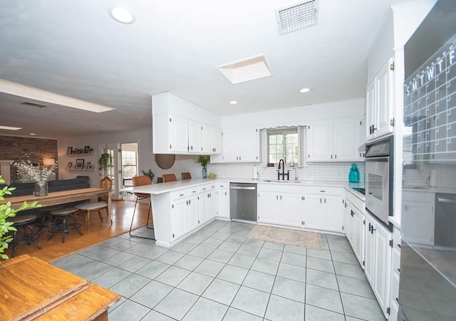 2718 Central Ave, Big Spring, TX 79720 - kitchen with stainless steel appliances, light tile patterned flooring, healthy amount of natural light, light countertops, and recessed lighting